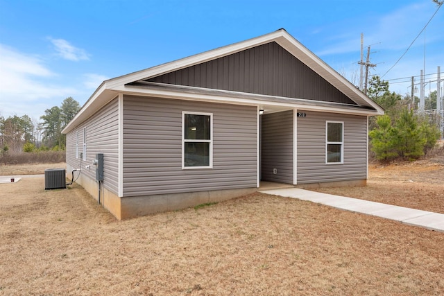 view of front facade with central AC unit and a front lawn