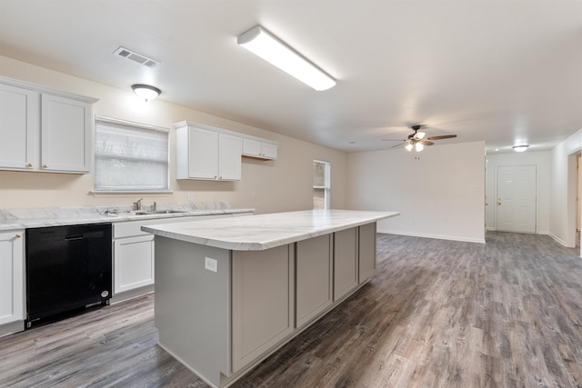 kitchen featuring sink, hardwood / wood-style flooring, white cabinetry, a center island, and black dishwasher