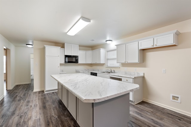 kitchen featuring white cabinetry, a kitchen island, sink, and dark hardwood / wood-style flooring