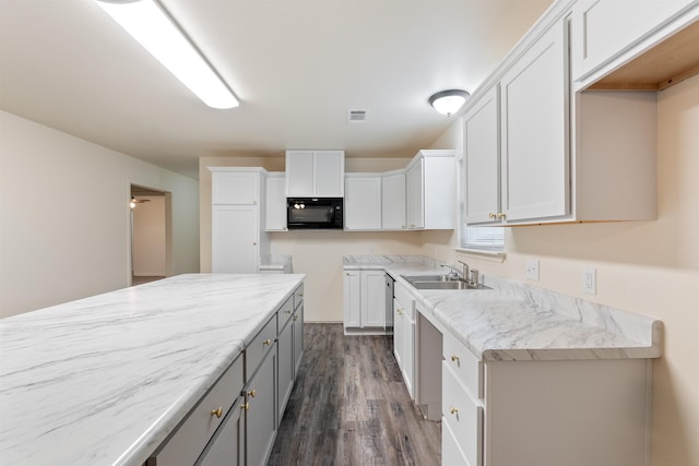 kitchen featuring white cabinetry, dark hardwood / wood-style flooring, dishwasher, and sink