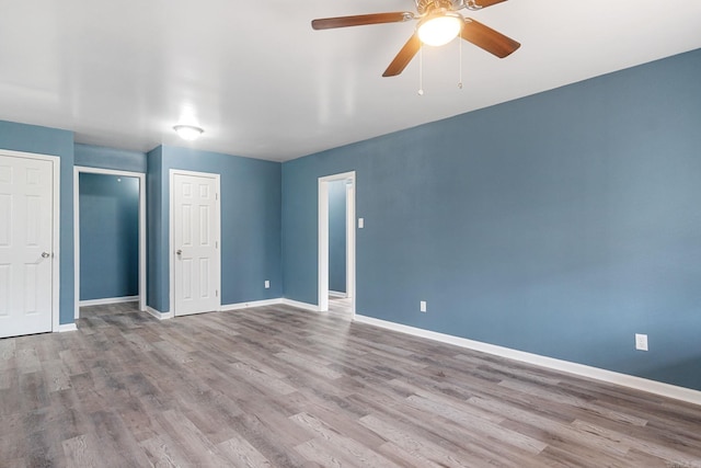 unfurnished bedroom featuring ceiling fan and light wood-type flooring