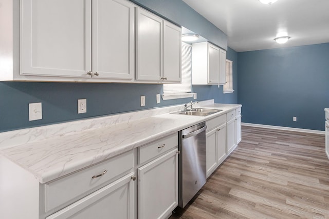 kitchen with sink, light wood-type flooring, dishwasher, light stone countertops, and white cabinets