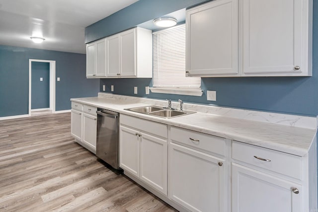 kitchen featuring sink, stainless steel dishwasher, light hardwood / wood-style floors, and white cabinets