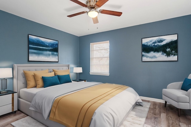 bedroom with hardwood / wood-style flooring and ceiling fan