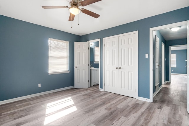 unfurnished bedroom featuring ceiling fan, light hardwood / wood-style floors, and a closet