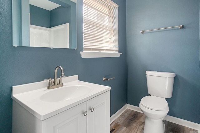 bathroom featuring vanity, hardwood / wood-style floors, and toilet