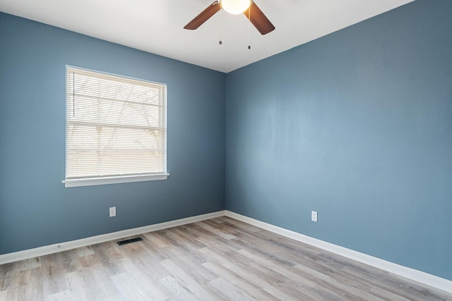 empty room with ceiling fan and light hardwood / wood-style floors