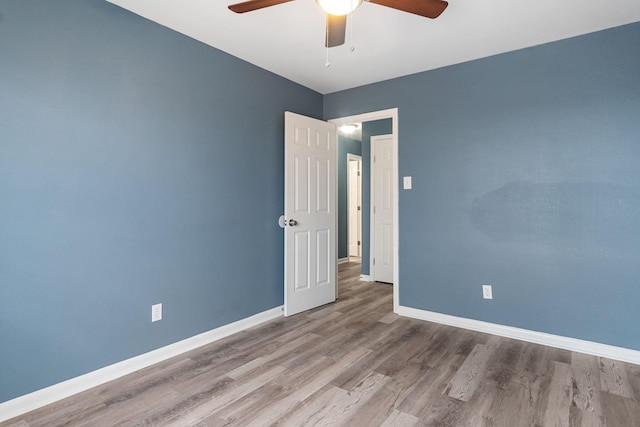 empty room featuring hardwood / wood-style flooring and ceiling fan