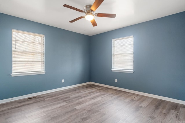 spare room featuring light hardwood / wood-style floors and ceiling fan