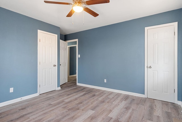 unfurnished bedroom featuring ceiling fan and light hardwood / wood-style flooring