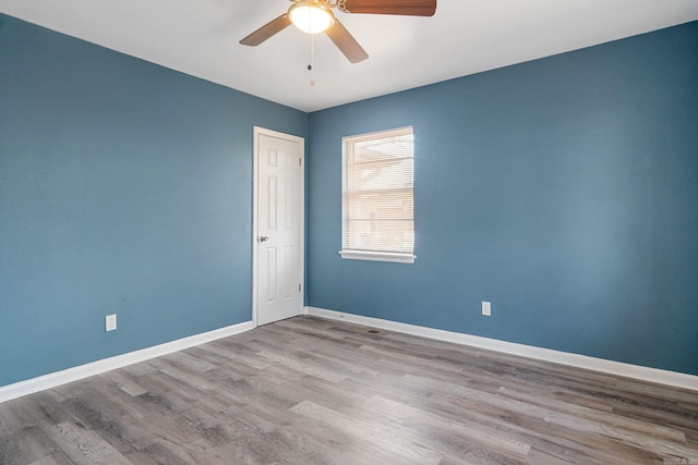 spare room featuring ceiling fan and light hardwood / wood-style floors