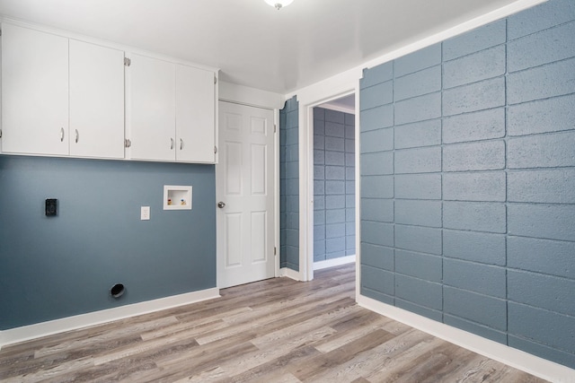 washroom featuring cabinets, washer hookup, and light wood-type flooring