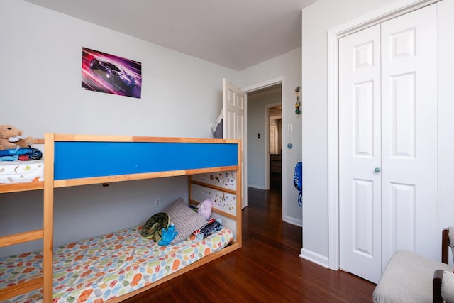 bedroom featuring dark hardwood / wood-style flooring and a closet