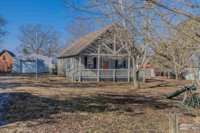 view of front facade featuring a garage, an outdoor structure, a playground, and covered porch