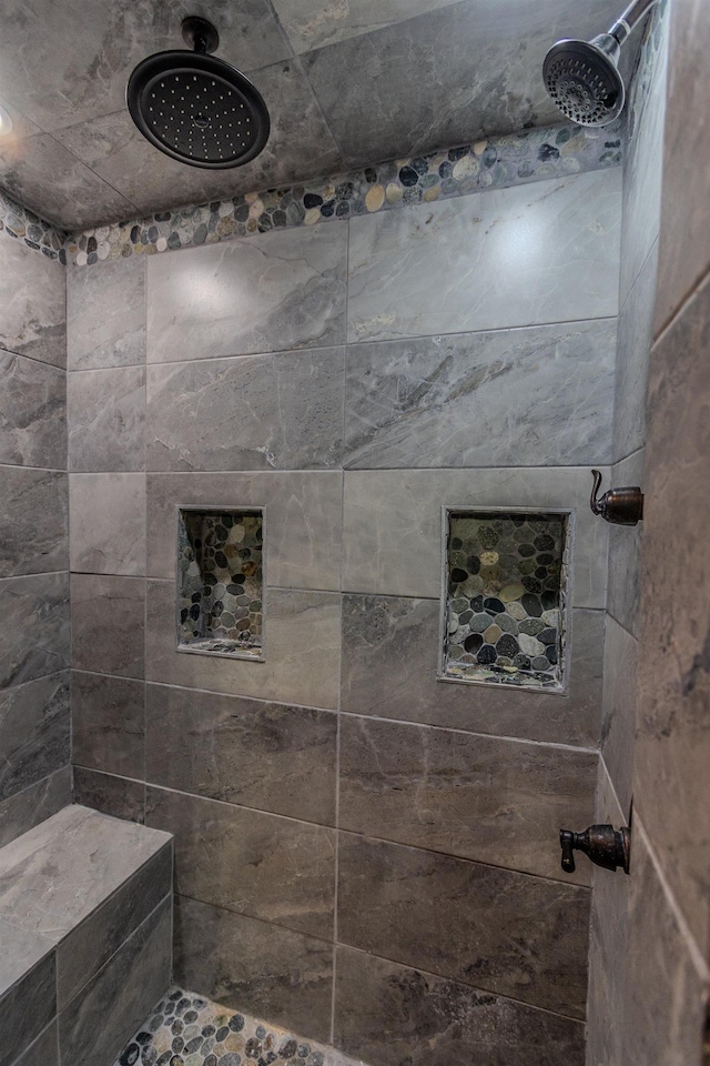 bathroom with a tile shower