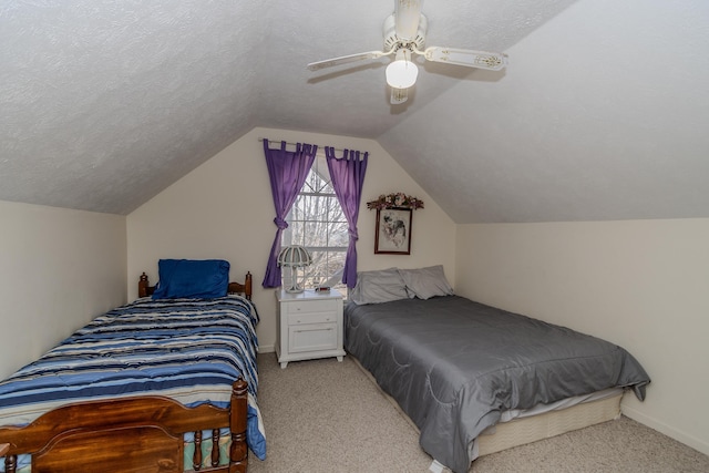 carpeted bedroom with ceiling fan, vaulted ceiling, and a textured ceiling