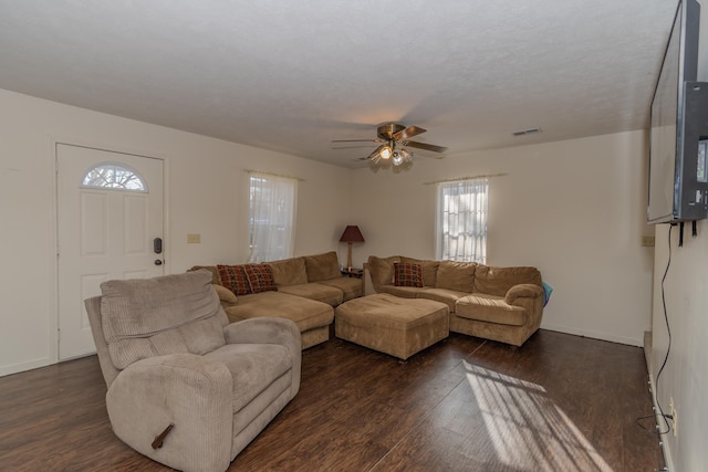 living room featuring dark hardwood / wood-style floors and ceiling fan