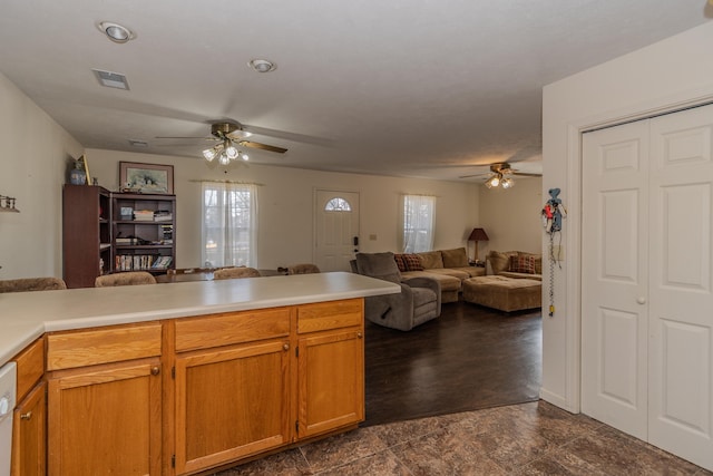 kitchen with ceiling fan, white dishwasher, and kitchen peninsula