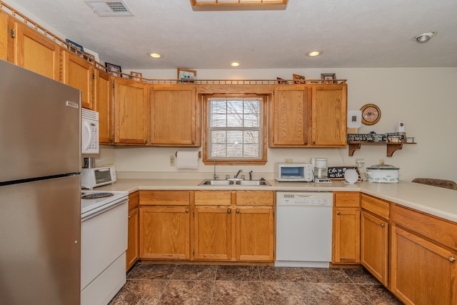 kitchen featuring sink, white appliances, and kitchen peninsula