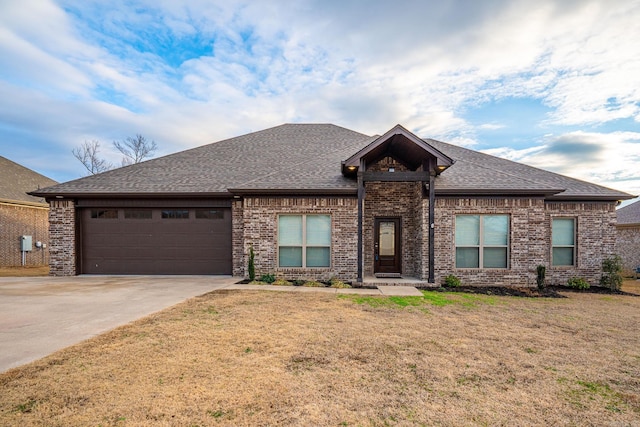 view of front of property with a garage and a front lawn