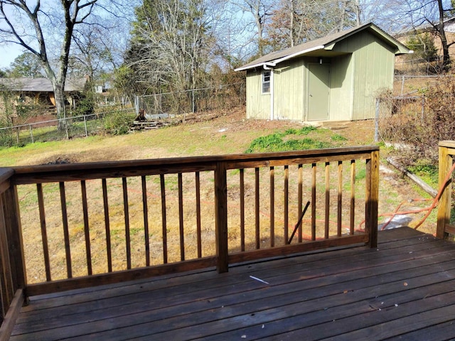 deck featuring a lawn and a storage unit