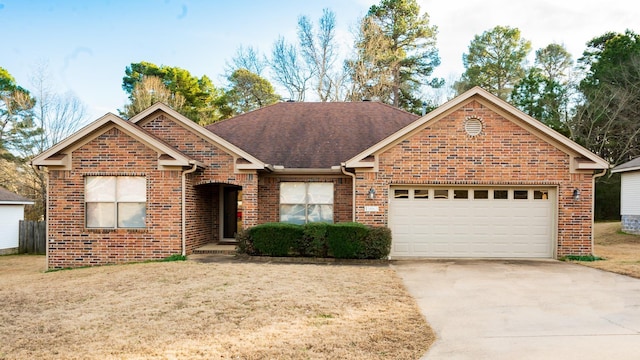 view of front of property featuring a garage and a front lawn