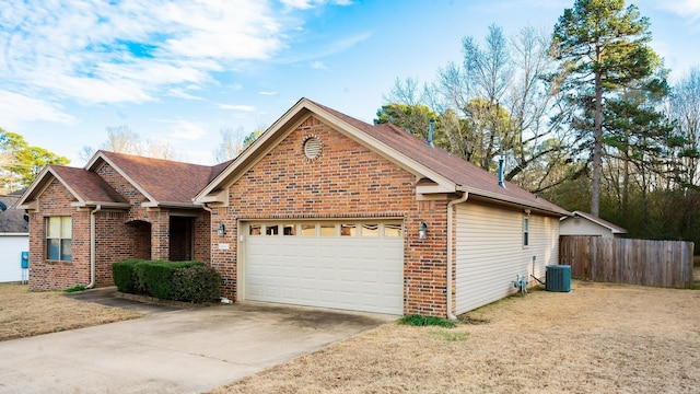 view of front of home featuring central AC unit and a garage