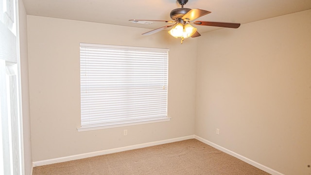 carpeted spare room with ceiling fan