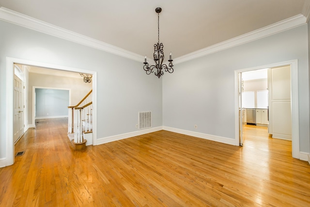 empty room featuring ornamental molding and light wood-type flooring