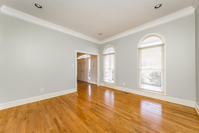 unfurnished room featuring crown molding and light hardwood / wood-style flooring