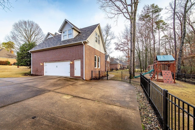 view of property exterior with a garage and a playground