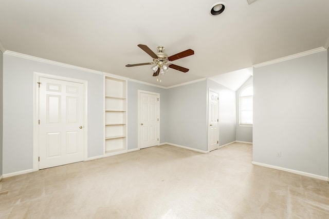 interior space with ornamental molding, light colored carpet, and ceiling fan