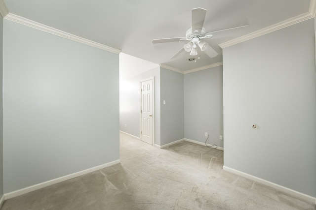 carpeted spare room with ceiling fan and ornamental molding