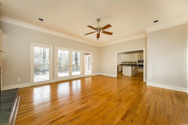 unfurnished living room with french doors, ceiling fan, ornamental molding, and light hardwood / wood-style floors