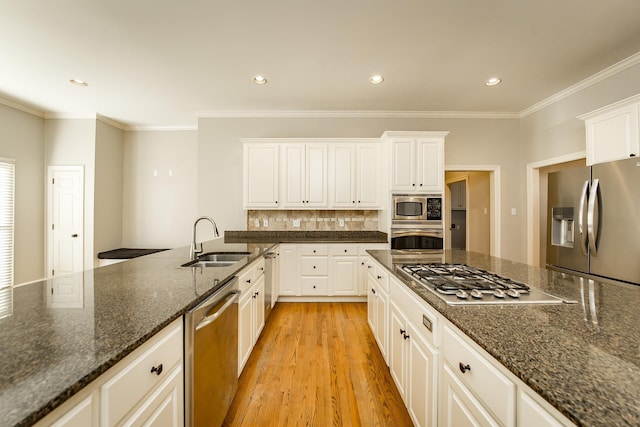 kitchen featuring white cabinetry, appliances with stainless steel finishes, sink, and dark stone countertops