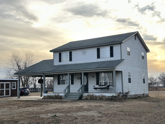 view of front of home with an outdoor structure and covered porch