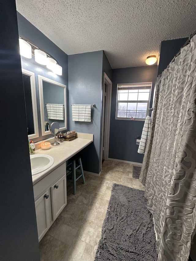 bathroom featuring vanity and a textured ceiling