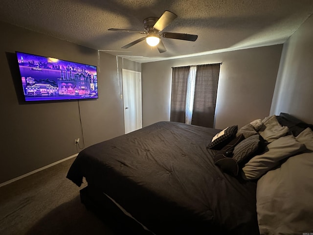 carpeted bedroom featuring ceiling fan and a textured ceiling