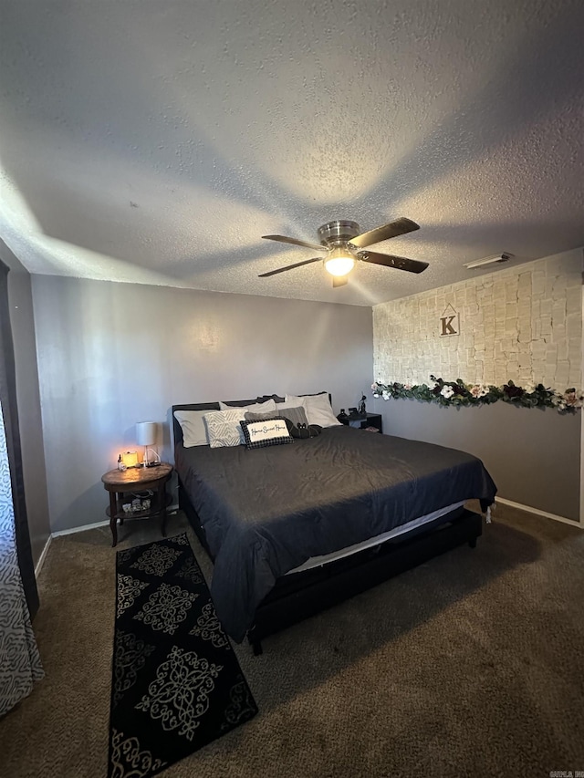 carpeted bedroom with a textured ceiling and ceiling fan