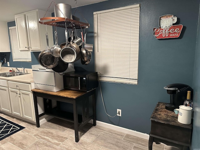 kitchen featuring sink and white cabinets