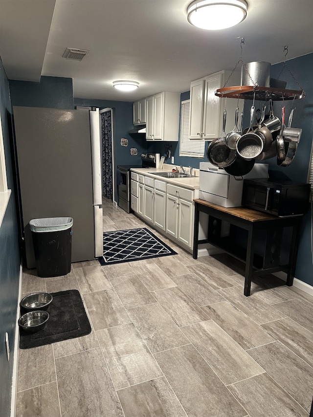 kitchen with white cabinetry, appliances with stainless steel finishes, and sink