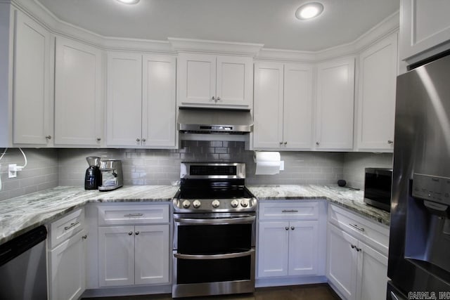 kitchen featuring appliances with stainless steel finishes, white cabinets, and backsplash