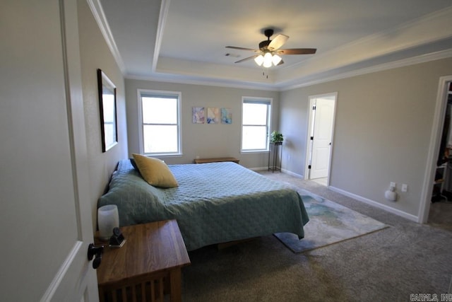 bedroom with a raised ceiling, crown molding, carpet flooring, and ceiling fan