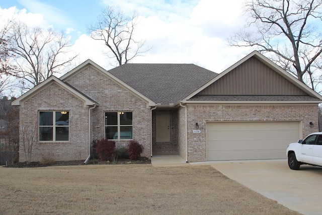 view of front of property featuring a garage and a front lawn