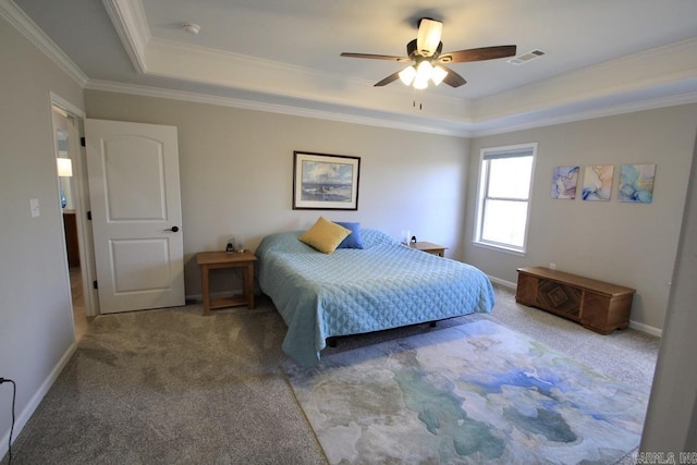 carpeted bedroom with ornamental molding, ceiling fan, and a tray ceiling