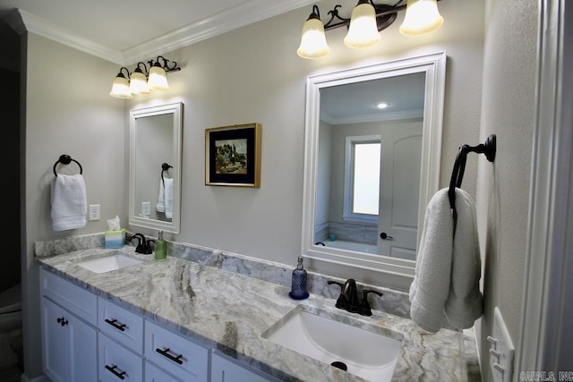 bathroom with ornamental molding and vanity