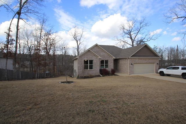 view of front of property featuring a garage and a front yard