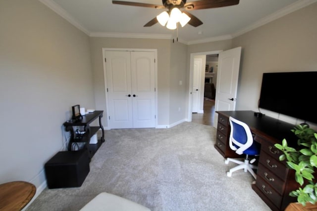 carpeted office space featuring crown molding and ceiling fan