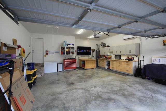 garage featuring a garage door opener, a workshop area, and an AC wall unit