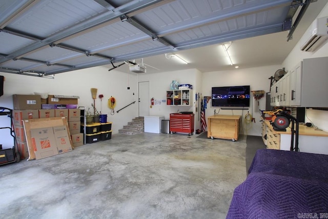 garage featuring a garage door opener and a wall unit AC